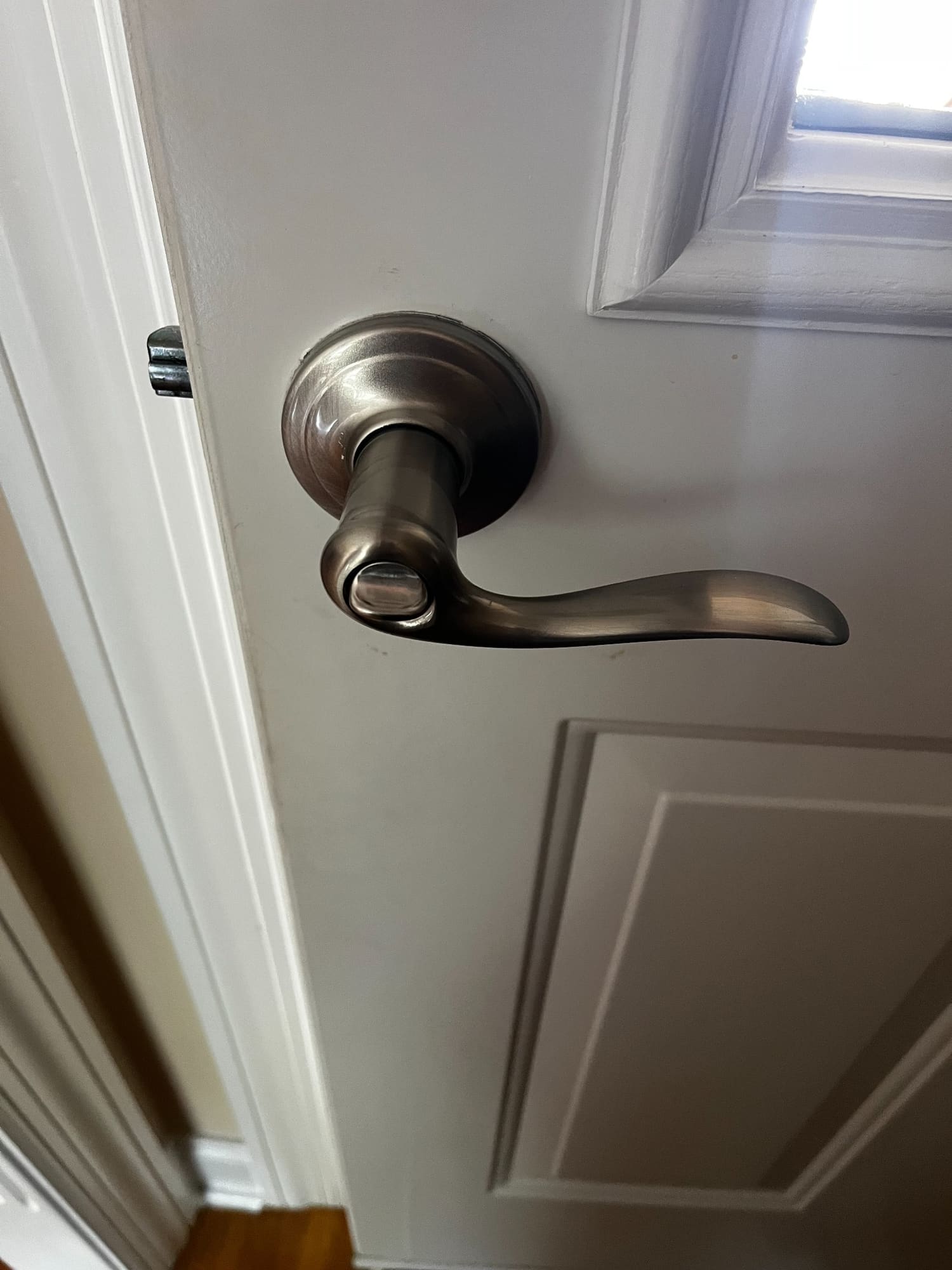 Brushed nickel door lever handle on white interior door